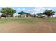 Expansive community playground area with multiple play structures and ample green space for outdoor activities at 38065 W Frascati Ave, Maricopa, AZ 85138