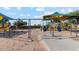 Colorful playground features swings, slides, and various play structures, offering a vibrant recreation space at 38065 W Frascati Ave, Maricopa, AZ 85138