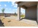 A covered patio looks onto a well manicured backyard, perfect for relaxing or entertaining at 38080 W Bello Ln, Maricopa, AZ 85138