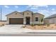 Charming single-story home with a two-car garage and desert landscaping at 38080 W Bello Ln, Maricopa, AZ 85138