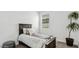 Cozy bedroom with neutral decor and a large potted plant, providing a relaxing atmosphere at 38100 W Bello Ln, Maricopa, AZ 85138