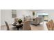 Inviting dining space with stylish furniture and ample natural light from the large windows at 38100 W Bello Ln, Maricopa, AZ 85138