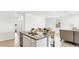 Modern kitchen featuring granite countertops, stainless steel appliances, and an island with bar seating at 38100 W Bello Ln, Maricopa, AZ 85138