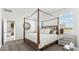 Spacious main bedroom with a canopy bed, neutral decor, and a serene atmosphere at 38100 W Bello Ln, Maricopa, AZ 85138