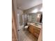 Cozy bathroom with wood vanity, framed mirror and tile flooring at 405 E Providence Dr, Casa Grande, AZ 85122