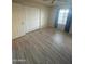 Bedroom featuring vinyl floors, a window and a spacious closet at 405 E Providence Dr, Casa Grande, AZ 85122