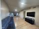 Bright living room features light wood floors, large comfortable sofa, fireplace and entertainment center at 405 E Providence Dr, Casa Grande, AZ 85122