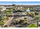 Gated Community entrance with lush landscaping and views of lake and fountains beyond at 4050 S Thistle S Dr, Chandler, AZ 85248