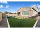 Inviting backyard with artificial turf, outdoor seating and covered patio area at 4050 S Thistle S Dr, Chandler, AZ 85248