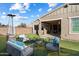 Relaxing backyard featuring low maintenance artificial turf and outdoor seating area with patio heater at 4050 S Thistle S Dr, Chandler, AZ 85248