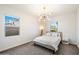 Bright bedroom with updated ceiling light, side table and two large windows at 4050 S Thistle S Dr, Chandler, AZ 85248