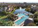 Aerial view of a luxurious community pool with fountain and lake surrounded by upscale homes at 4050 S Thistle S Dr, Chandler, AZ 85248
