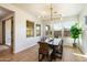 Bright dining room with large windows, modern light fixture, and a stylish table perfect for Gathering meals at 4050 S Thistle S Dr, Chandler, AZ 85248