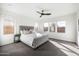 Bright main bedroom with decorative ceiling fan and three large windows at 4050 S Thistle S Dr, Chandler, AZ 85248