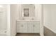 Modern bathroom features double sinks, mirrors, and neutral tones, enhanced by natural light from shower at 4167 W Lisa Ln, San Tan Valley, AZ 85144