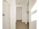 Hallway view leading to bathroom with glass shower, tile flooring, walk-in closet and neutral-toned walls at 4167 W Lisa Ln, San Tan Valley, AZ 85144