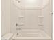 Clean white bathtub with showerhead and storage shelving for a relaxing bathing experience at 4167 W Lisa Ln, San Tan Valley, AZ 85144