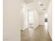 Bright hallway features neutral tile flooring and fresh white walls leading to an open room with carpet at 4167 W Lisa Ln, San Tan Valley, AZ 85144