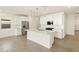 Bright open kitchen with stainless steel appliances, white cabinets, and island with pendant lighting at 4167 W Lisa Ln, San Tan Valley, AZ 85144