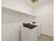 Efficient laundry room equipped with modern washer and dryer, complemented by storage shelving overhead at 4167 W Lisa Ln, San Tan Valley, AZ 85144
