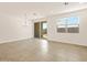 Bright living area with tile floors, modern chandelier, and sliding glass door at 4167 W Lisa Ln, San Tan Valley, AZ 85144