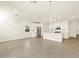 Open-concept living room showcasing stainless steel appliances, tile flooring, and modern lighting fixtures at 4167 W Lisa Ln, San Tan Valley, AZ 85144