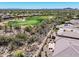 Expansive aerial view of community golf course, desert landscaping, mountain views, and backyard pool at 41731 N Rolling Green Way, Anthem, AZ 85086