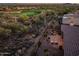 Desert home showcases its luxurious back patio with a fire pit and outdoor kitchen at 41731 N Rolling Green Way, Anthem, AZ 85086