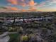 Scenic aerial shot of luxury homes with desert landscaping at sunset, offering breathtaking views and a serene neighborhood at 41731 N Rolling Green Way, Anthem, AZ 85086