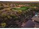 Gorgeous aerial view of a home and its manicured golf course in the distance at 41731 N Rolling Green Way, Anthem, AZ 85086