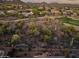 Expansive aerial view of an upscale home near a golf course, showcasing beautiful desert landscaping and mountain views at 41731 N Rolling Green Way, Anthem, AZ 85086