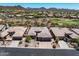 Aerial view of desert home with manicured landscaping, three-car garage, and tile roof at 41731 N Rolling Green Way, Anthem, AZ 85086