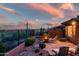 Desert home featuring a beautiful back patio with a fire pit, desert landscaping, and sunset views at 41731 N Rolling Green Way, Anthem, AZ 85086