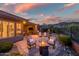 Home showcasing a gorgeous back patio with fire pit, outdoor seating, and desert landscaping at 41731 N Rolling Green Way, Anthem, AZ 85086
