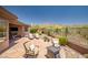 Serene backyard oasis with desert views, flagstone patio, seating, and lush landscaping at 41731 N Rolling Green Way, Anthem, AZ 85086