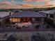 Aerial view of the backyard patio with lounge seating and a fire pit, perfect for relaxing and entertaining outdoors at 41731 N Rolling Green Way, Anthem, AZ 85086