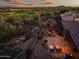 Backyard featuring a stone patio with a fire pit, perfect for cozy evenings spent outdoors in a serene environment at 41731 N Rolling Green Way, Anthem, AZ 85086