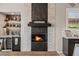 This elegant bar is crafted with wine storage and a built-in fireplace for a cozy atmosphere at 41731 N Rolling Green Way, Anthem, AZ 85086