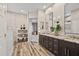 Bathroom with double vanity, wood floors, and decorative accents at 41731 N Rolling Green Way, Anthem, AZ 85086