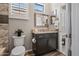 Stylish bathroom with a modern vanity, granite countertop, and decorative mirrors at 41731 N Rolling Green Way, Anthem, AZ 85086