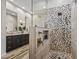 Stylish bathroom featuring a double vanity and decorative shower at 41731 N Rolling Green Way, Anthem, AZ 85086
