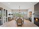 Bright dining room with natural light, a modern fireplace, and a bar area with a wine cooler at 41731 N Rolling Green Way, Anthem, AZ 85086