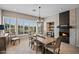 Bright dining room boasts a fireplace and large windows, bringing a comfortable space for dining at 41731 N Rolling Green Way, Anthem, AZ 85086