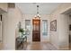 Elegant foyer with tile flooring, decorative lighting and stylish console table creating a warm welcome at 41731 N Rolling Green Way, Anthem, AZ 85086
