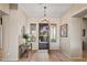 Bright foyer with tile flooring, and an open doorway with security screen, enhancing the entry's functionality at 41731 N Rolling Green Way, Anthem, AZ 85086