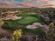 Aerial view of a lush green golf course with sand traps and manicured landscaping, offering a picturesque playing experience at 41731 N Rolling Green Way, Anthem, AZ 85086