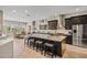 Spacious kitchen with dark wood cabinets, large center island and modern stainless steel appliances at 41731 N Rolling Green Way, Anthem, AZ 85086