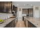Modern kitchen with granite countertops, stainless steel appliances, and ample cabinet space at 41731 N Rolling Green Way, Anthem, AZ 85086