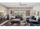 Comfortable living room featuring plantation shutters, a ceiling fan and stylish furnishings at 41731 N Rolling Green Way, Anthem, AZ 85086