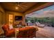 Elegant patio with comfortable seating, ceiling fan, outdoor grill, and mountain views at 41731 N Rolling Green Way, Anthem, AZ 85086